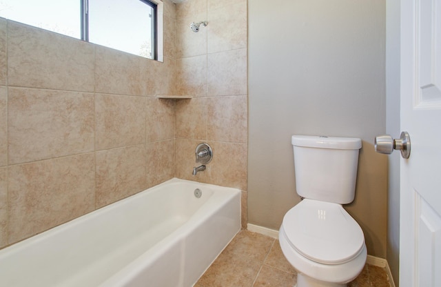 bathroom with tile patterned floors, toilet,  shower combination, and baseboards