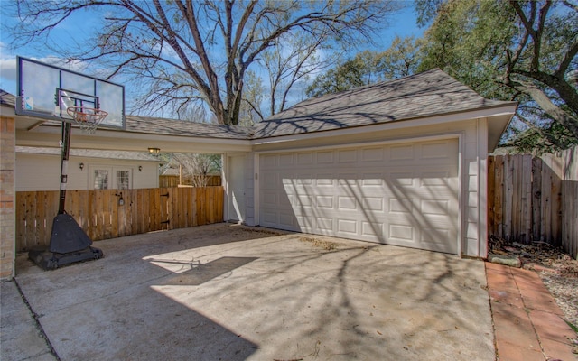 detached garage featuring fence