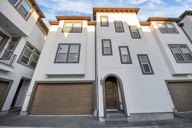 view of property with stucco siding and a garage