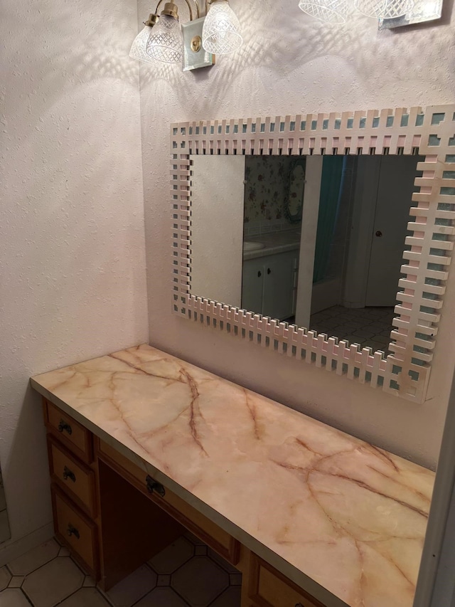 bathroom with vanity and a textured wall