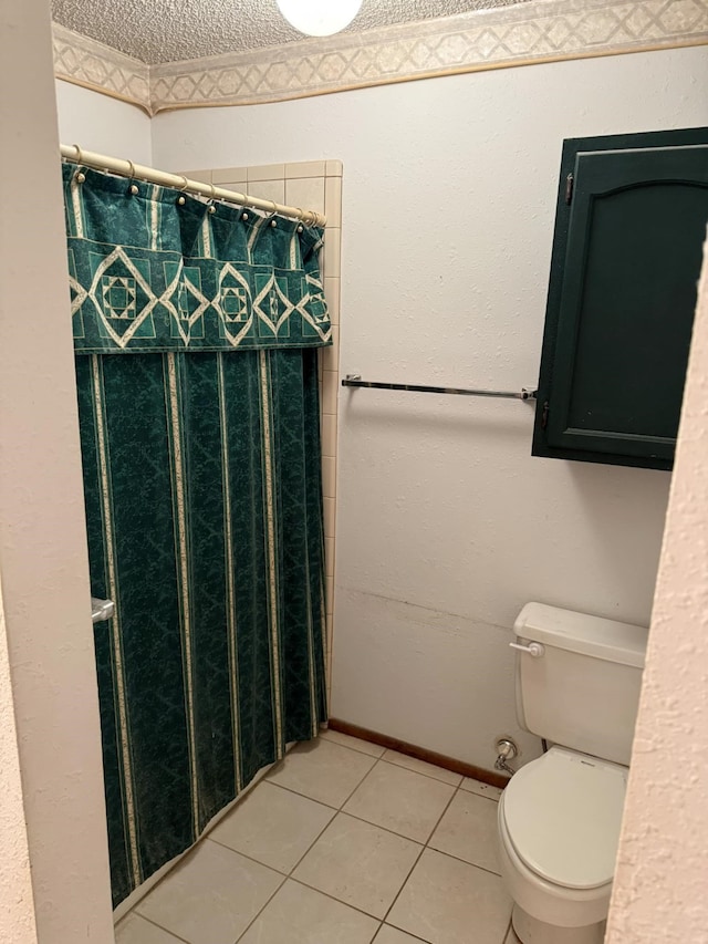 full bathroom with tile patterned floors, a textured ceiling, toilet, and a shower with curtain