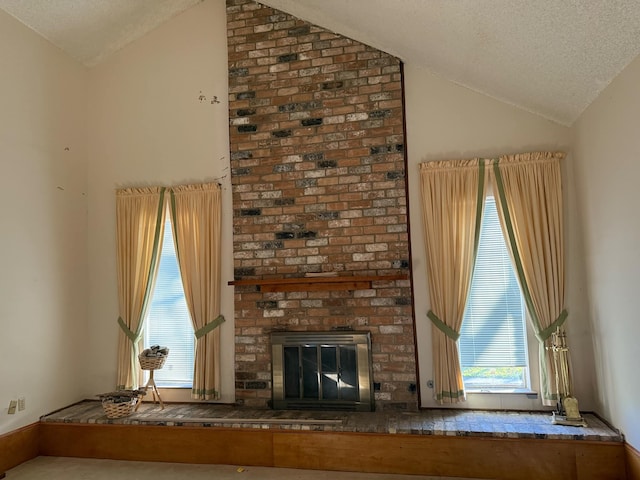 unfurnished living room with lofted ceiling, a brick fireplace, and a textured ceiling