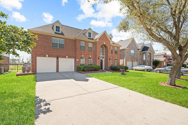 georgian-style home with brick siding, fence, concrete driveway, a front yard, and an attached garage