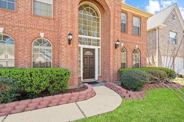 doorway to property featuring brick siding