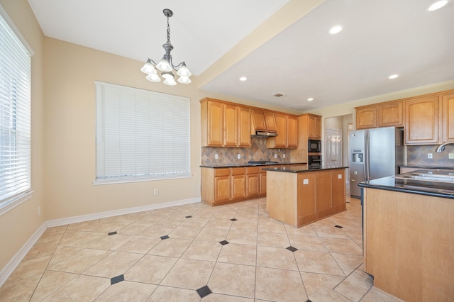 kitchen with light tile patterned floors, stainless steel appliances, under cabinet range hood, tasteful backsplash, and a center island