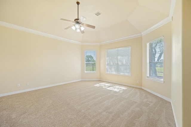 spare room featuring ornamental molding, baseboards, visible vents, and light carpet