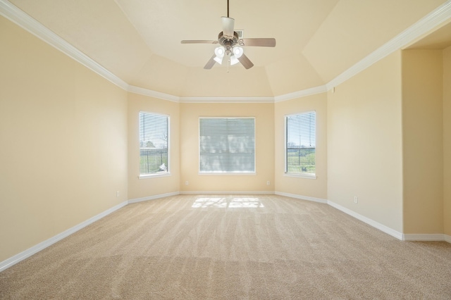 empty room featuring a wealth of natural light, light carpet, and baseboards