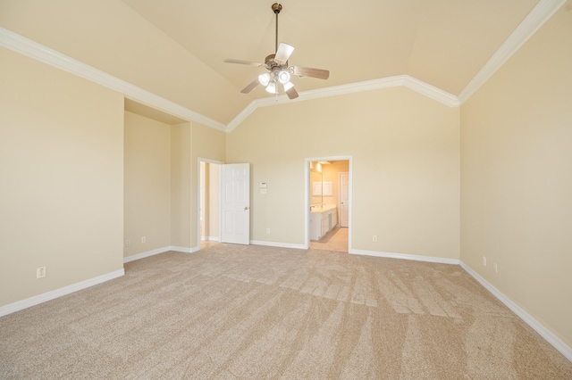 unfurnished bedroom with ornamental molding, ensuite bath, baseboards, light colored carpet, and vaulted ceiling