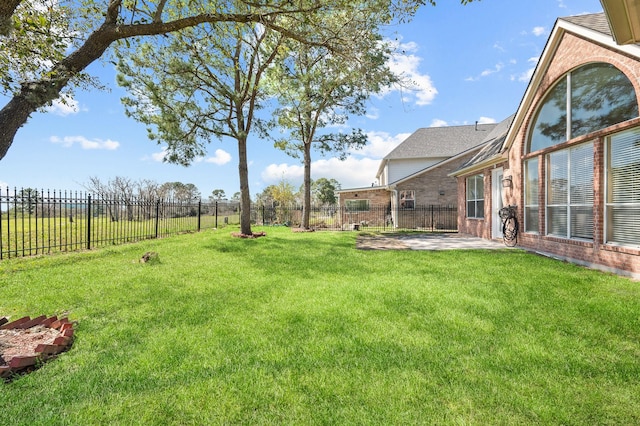 view of yard with a patio area and a fenced backyard