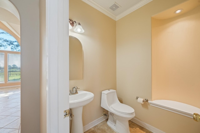 bathroom with tile patterned flooring, visible vents, baseboards, toilet, and ornamental molding