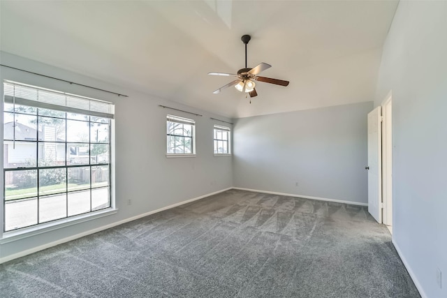 carpeted spare room featuring baseboards, a ceiling fan, and vaulted ceiling