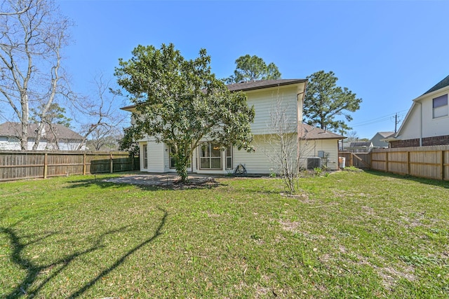 rear view of house with cooling unit, a lawn, and a fenced backyard