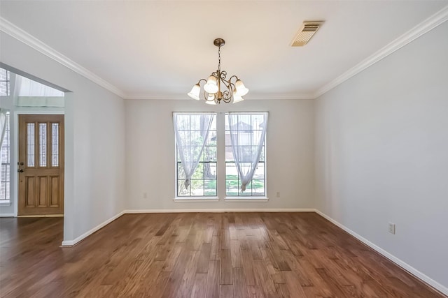 interior space featuring visible vents, crown molding, baseboards, and wood finished floors