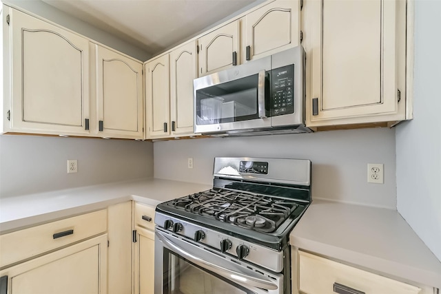 kitchen featuring light countertops, cream cabinets, and stainless steel appliances