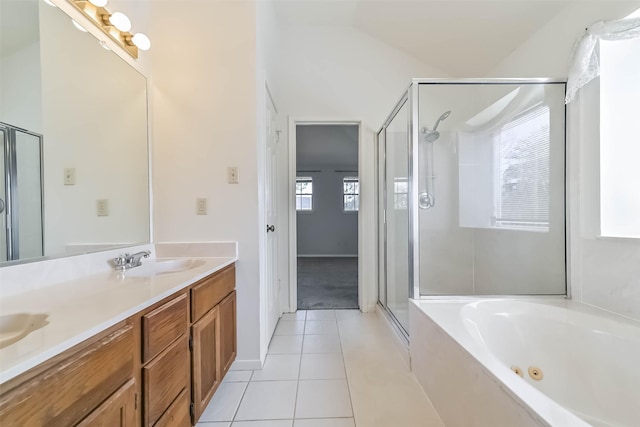 bathroom with a sink, a jetted tub, a shower stall, and tile patterned flooring