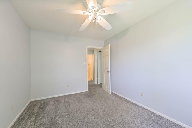 empty room featuring a ceiling fan, baseboards, and carpet floors