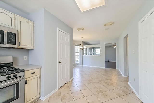 kitchen with visible vents, light countertops, light tile patterned floors, appliances with stainless steel finishes, and cream cabinets