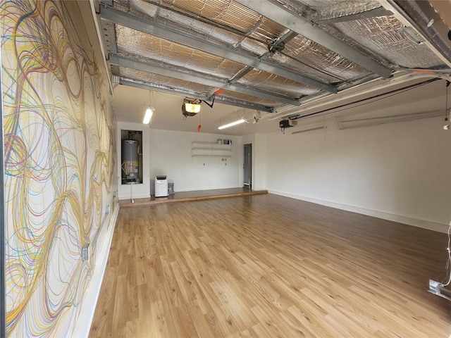 garage with a garage door opener, baseboards, and water heater