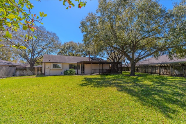 exterior space featuring a fenced backyard and a yard