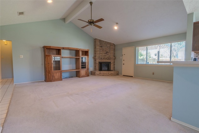 unfurnished living room with light carpet, beamed ceiling, a brick fireplace, and high vaulted ceiling