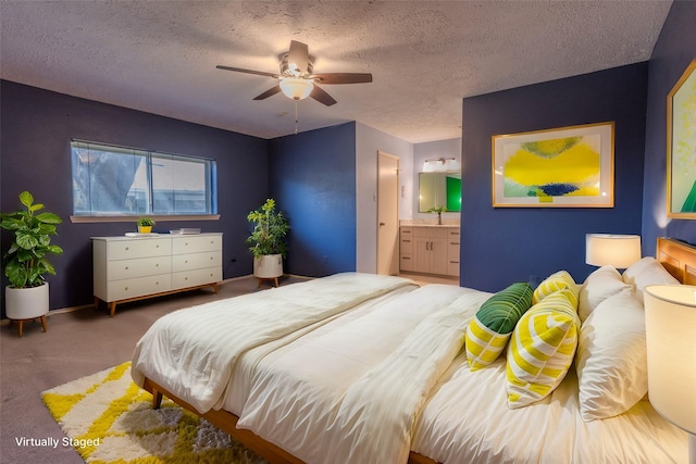 carpeted bedroom with ensuite bath, a textured ceiling, ceiling fan, and a sink