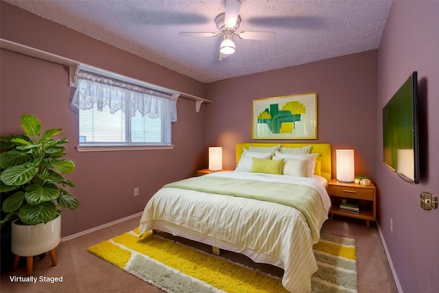 carpeted bedroom with baseboards, a textured ceiling, and ceiling fan