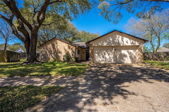 view of front of property featuring brick siding, concrete driveway, an attached garage, and fence