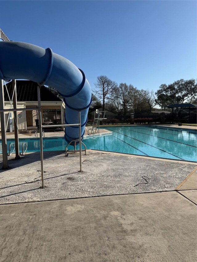 pool featuring a patio area and a water slide