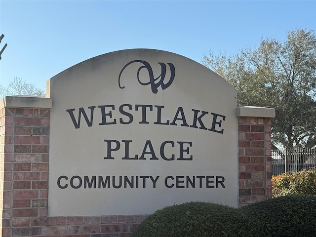 community sign featuring fence