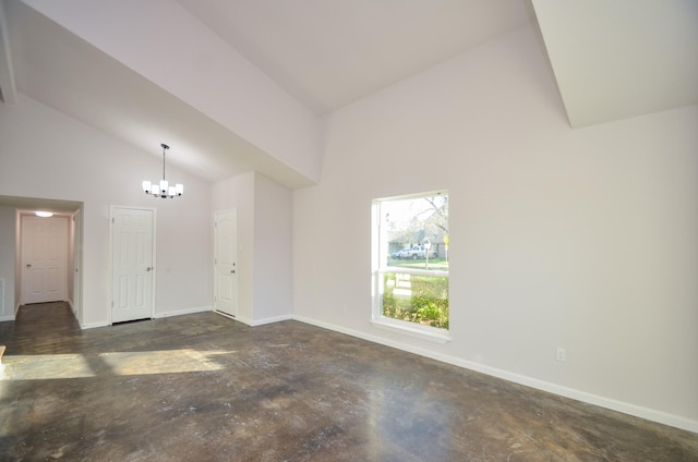 unfurnished living room featuring baseboards, unfinished concrete flooring, high vaulted ceiling, and an inviting chandelier