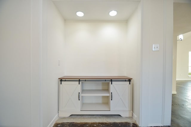 interior details featuring baseboards and concrete floors