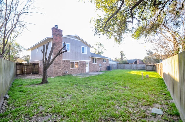 view of yard with a patio area, central AC unit, and a fenced backyard