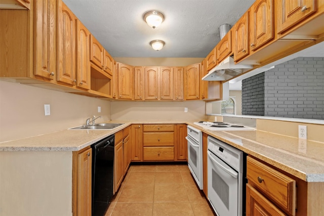 kitchen with a sink, under cabinet range hood, a textured ceiling, white appliances, and light tile patterned flooring