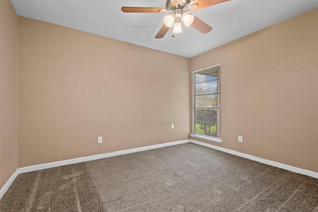 carpeted empty room with baseboards and a ceiling fan