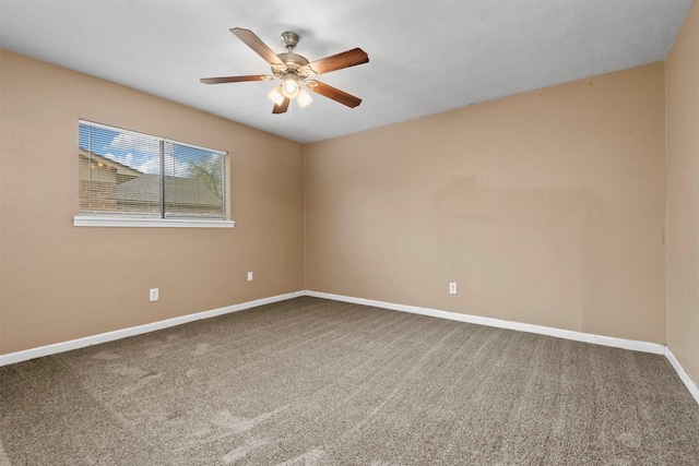 unfurnished room with baseboards, carpet, and a ceiling fan