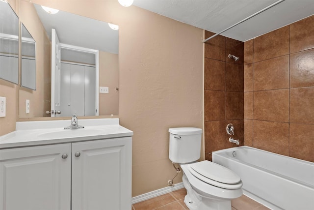 full bathroom featuring tile patterned flooring, baseboards, toilet, bathing tub / shower combination, and vanity