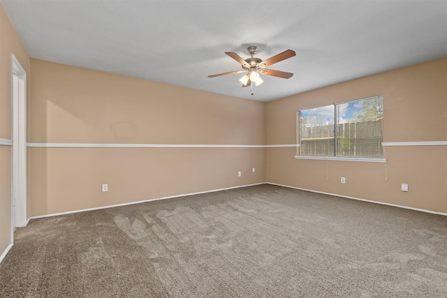 spare room featuring carpet and ceiling fan