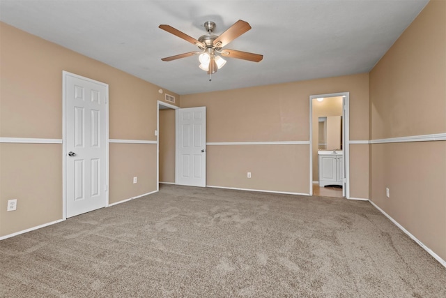 unfurnished bedroom featuring baseboards, visible vents, carpet floors, and connected bathroom