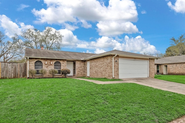 view of front of property with a front yard, fence, a garage, and driveway