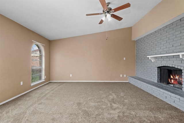 unfurnished living room featuring baseboards, carpet floors, a brick fireplace, and a ceiling fan