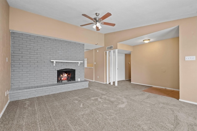 unfurnished living room featuring visible vents, a brick fireplace, carpet, vaulted ceiling, and a ceiling fan