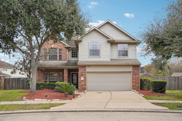 traditional-style house featuring brick siding, an attached garage, driveway, and fence