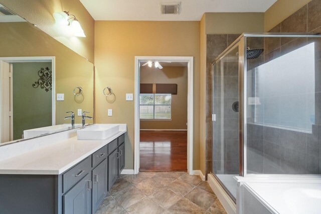 bathroom with visible vents, a shower stall, vanity, and baseboards