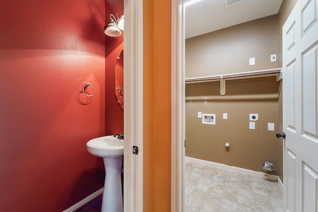 bathroom with a sink and baseboards