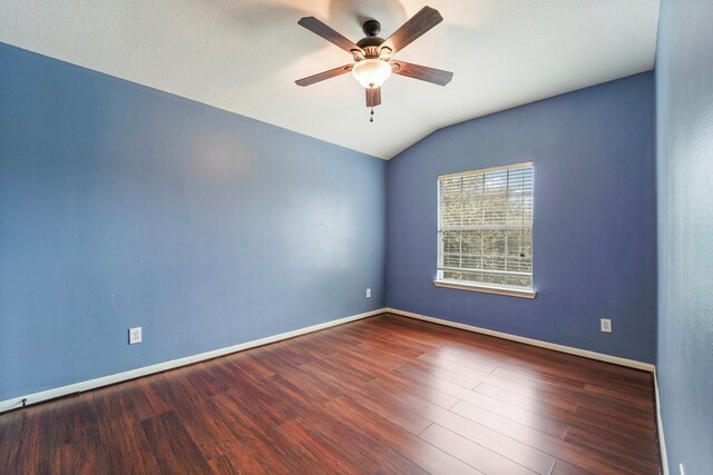 unfurnished room with lofted ceiling, wood finished floors, baseboards, and ceiling fan