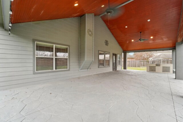 view of patio with ceiling fan and fence