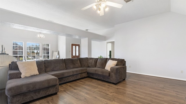 living room featuring dark wood finished floors, visible vents, ceiling fan with notable chandelier, and baseboards