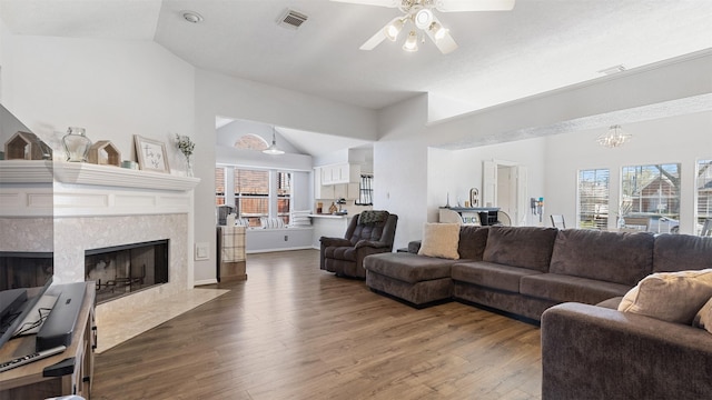 living area featuring visible vents, a healthy amount of sunlight, and wood finished floors