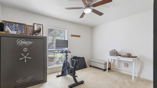 exercise room featuring carpet flooring, a ceiling fan, baseboards, and a textured ceiling