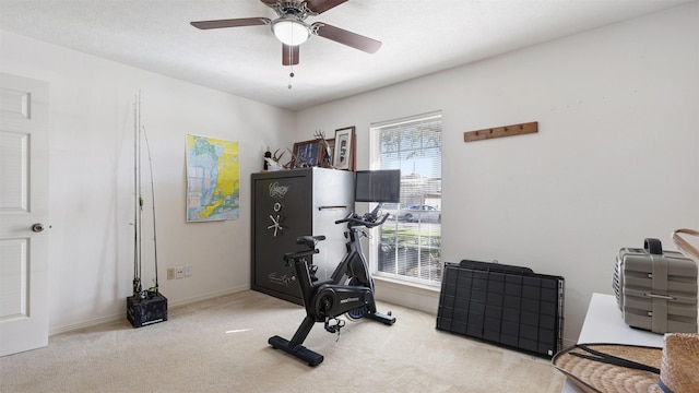 exercise area with ceiling fan, baseboards, and carpet